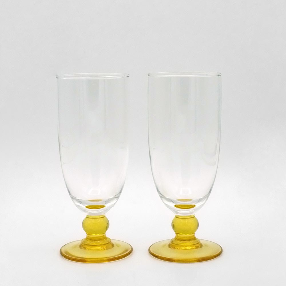  TWO CHAMPAGNE GLASSES WITH AMBER COLOURED GLASS BASE